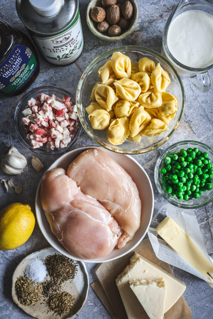 Ingredients for chicken tortellini with lemon herb marinade, Alfredo sauce, fresh tortellini, peas, pancetta, and seasonings