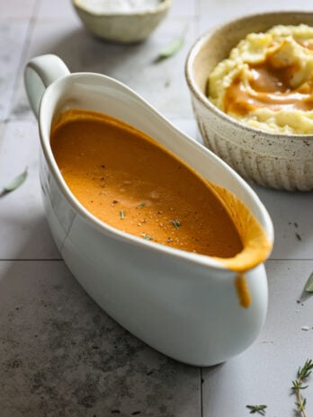 Smooth turkey gravy served in a white gravy boat, glossy and richly colored, ready to pour over mashed potatoes